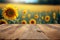 Focus empty wood table with blurred sunflower tree background.