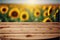 Focus empty wood table with blurred sunflower tree background.