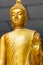 Focus on face of Yellow image of buddha standing