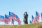 Focus of father in military uniform standing with cute kid near american flags