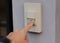 Focus on finger pressed on the doorbell