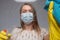 Focus on glass. Cleaning with viruses and bacteria at home. The girl in the mask cleans with a chemical agent in the mask and