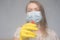 Focus on glass. Cleaning with viruses and bacteria at home. The girl in the mask cleans with a chemical agent in the mask and