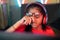 focus on hand, tired exhausted girl kid rubbing eyes by removing eyeglasses while playing online video game at home -