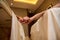 Focus on the hands of the couple in love, lying on the massage table and holding hand in hand during body care at the spa wellness