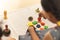 Focus on hands of cute little child girl playing with Indian wooden channapatna toys in the room