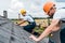 Focus of handsome handyman repairing roof with colleague