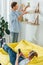 Focus of handsome man cleaning shelf