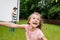 Focus of happy kid smiling near father outside