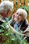 Focus of happy woman with grey hair looking at retired husband