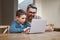 Focus and itll make sense. a father and son team using a laptop to complete school work.