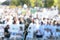 Focus on microphone, blurred group of people at mass protest or public demonstration in the background