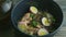 Focus in at noodles dish with shiitake mushrooms, boiled eggs, and pitcher with broth