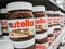 Focus on Nutella jars of hazelnut cream in french supermaket shelf. Nutella is a brand of products made in Italy by Ferrero