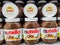 Focus on Nutella jars of hazelnut cream in french supermaket shelf. Nutella is a brand of products made in Italy by Ferrero