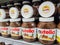 Focus on Nutella jars of hazelnut cream in french supermaket shelf. Nutella is a brand of products made in Italy by Ferrero