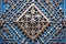 focus on an ornate metal star of david affixed to an exterior wall