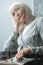 Focus of pensive disabled senior woman with grey hair