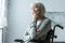 Focus of pensive disabled senior woman with grey hair