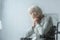 Focus of pensive disabled senior woman with grey hair