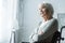 Focus of pensive disabled senior woman with grey hair