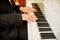 Focus pianist`s hand on piano keys. orchestra musical instrument. romantic sound origins.