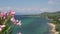 Focus from pink flower to coastline and beach at Thassos island, Greece