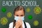 Focus of schoolgirl touching medical mask