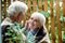 Focus of senior man with grey hair touching face of retired wife