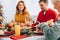 Focus of smiling grandma eating, sitting