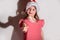 Focus on sparklers. merry girl in a red cap celebrates Christmas in blur on a white background