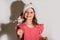 Focus on sparklers. smiling girl in a red cap celebrates Christmas in blur on a white background