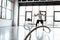 Focus of sportsman exercising with battle ropes in modern gym