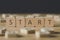 Focus of start inscription on cubes surrounded by blocks with letters on wooden surface isolated on black