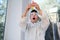 Focus on test tubes in the hands of a schoolboy in white lab coat and goggles observing a chemical reaction taking place