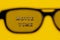 Focus on text Movie time through 3D glasses on yellow paper background. Concept cinema movie and entertainment
