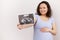 Focus on ultrasound scan image, baby sonography in the hand of a smiling pregnant woman,  on white background