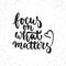 Focus on what matters - hand drawn lettering phrase isolated on the white grunge background. Fun brush ink inscription