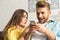 Focus of woman looking at cheerful boyfriend with smartphone