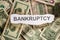 Focus on the word BANKRUPTCY on piece of torn white paper with b