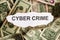 Focus on the word CYBER CRIME on piece of torn white paper with