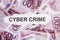 Focus on the word CYBER CRIME on piece of torn white paper with