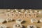 Focus of word student made of cubes surrounded by blocks with letters on wooden surface isolated on black