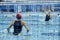 Focus on young woman throwing ball to gate of rival team during water polo game