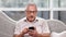 Focused 70s elderly man hold mobile surfing internet. Medium close up shot on 4k RED camera