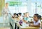 Focused aframerican preteen schoolgirl writing in workbook in class