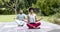 Focused african american couple practicing yoga meditation sitting in garden, slow motion