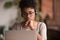 Focused african american girl student wearing headphones looking at laptop