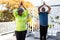 Focused african american senior couple practicing yoga in garden