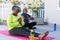 Focused african american senior couple practicing yoga on mat in garden